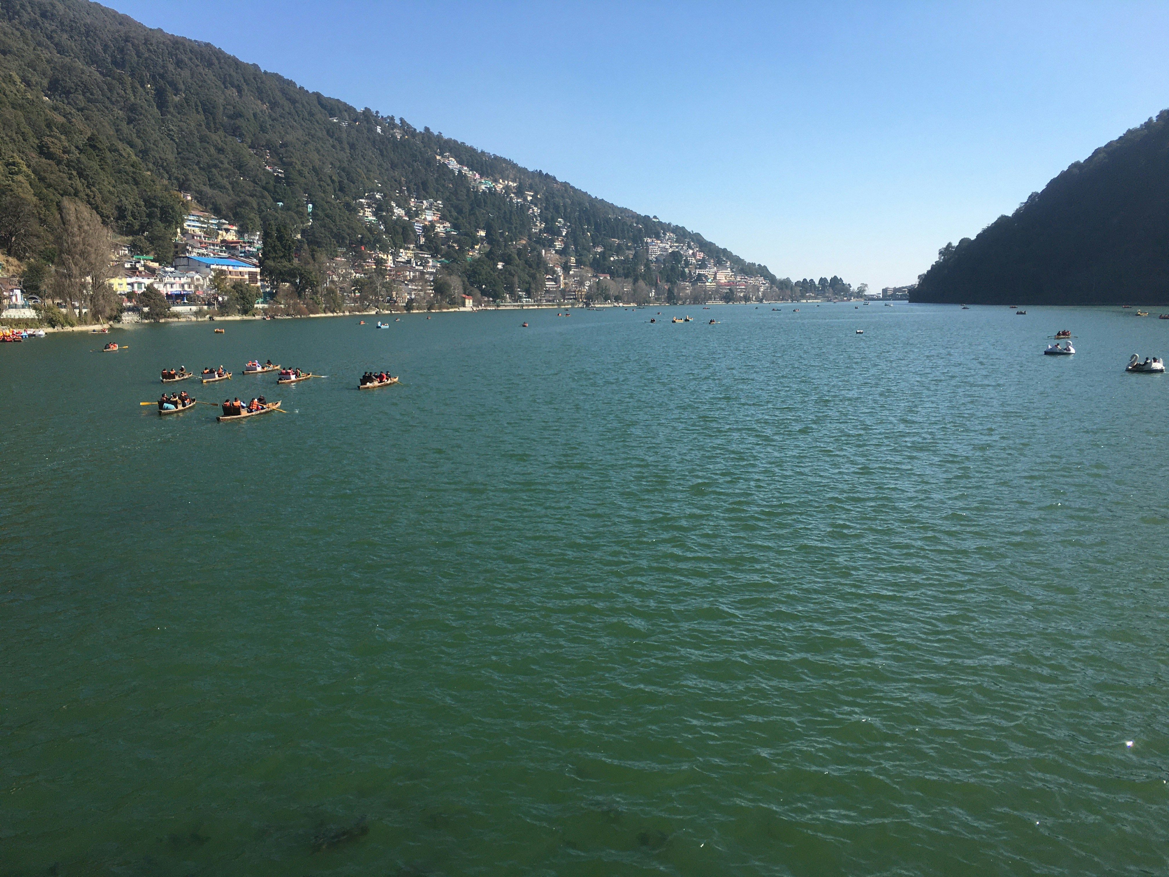 a group of boats floating on top of a lake