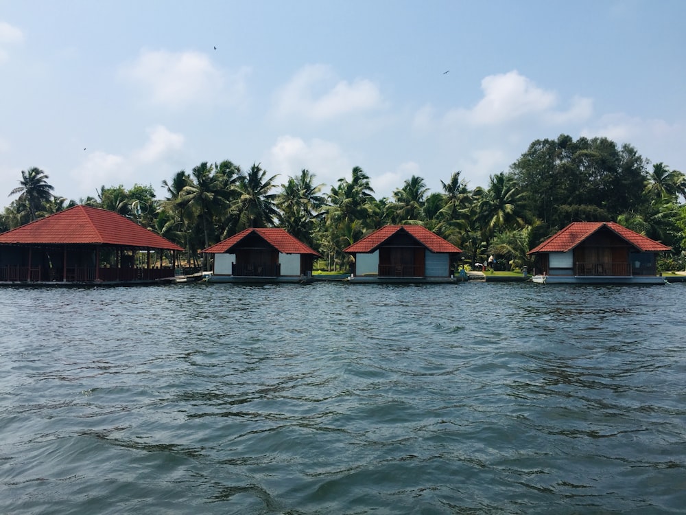 a row of houses sitting on top of a body of water