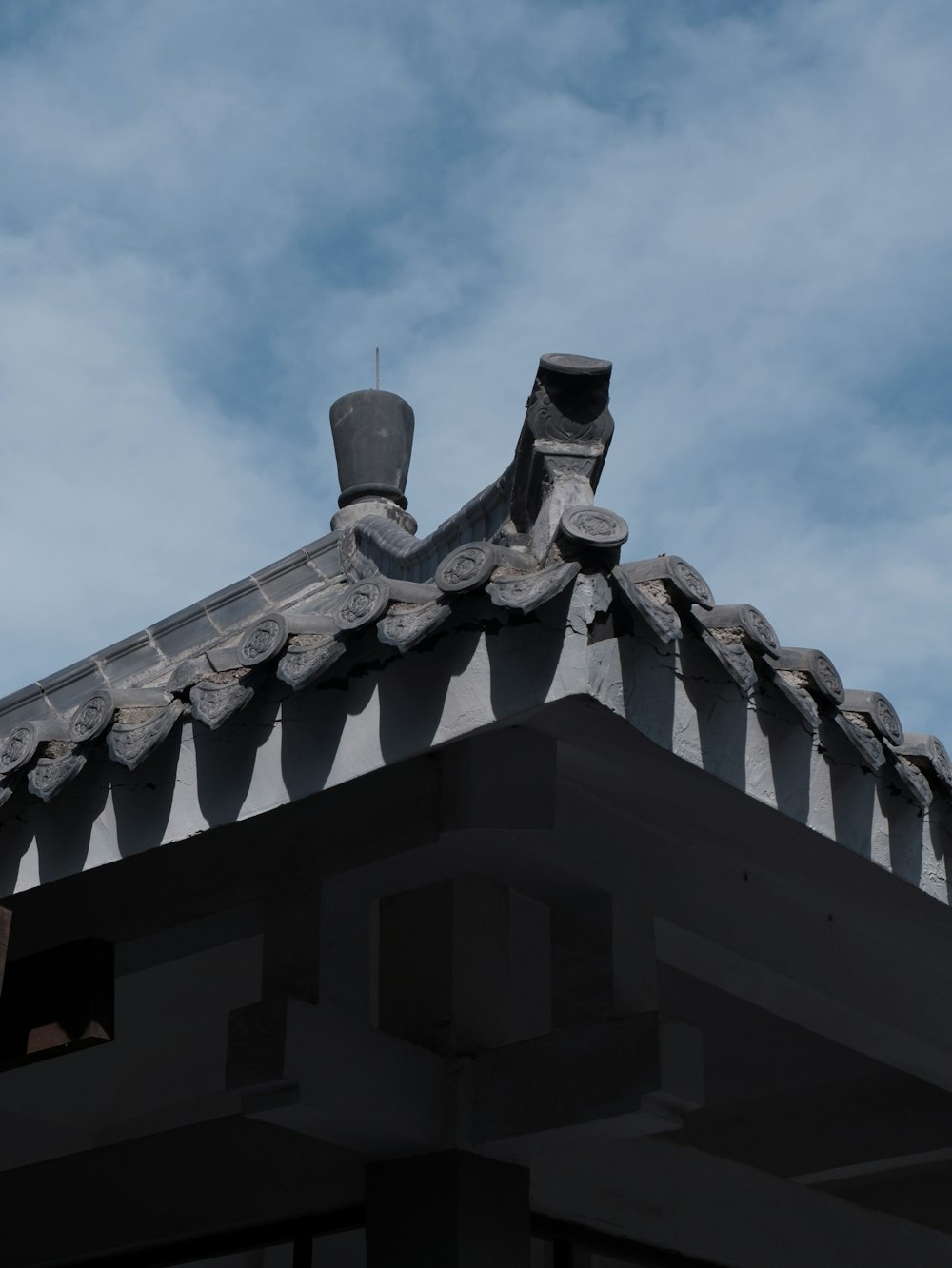 the roof of a building with a sky background