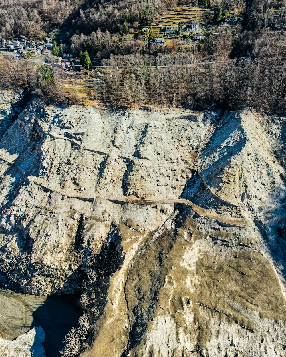 an aerial view of a mountain with a road going through it