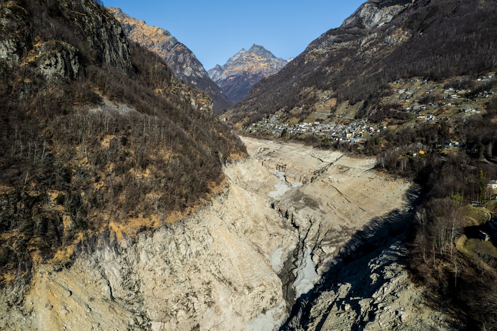 an aerial view of a valley with mountains in the background