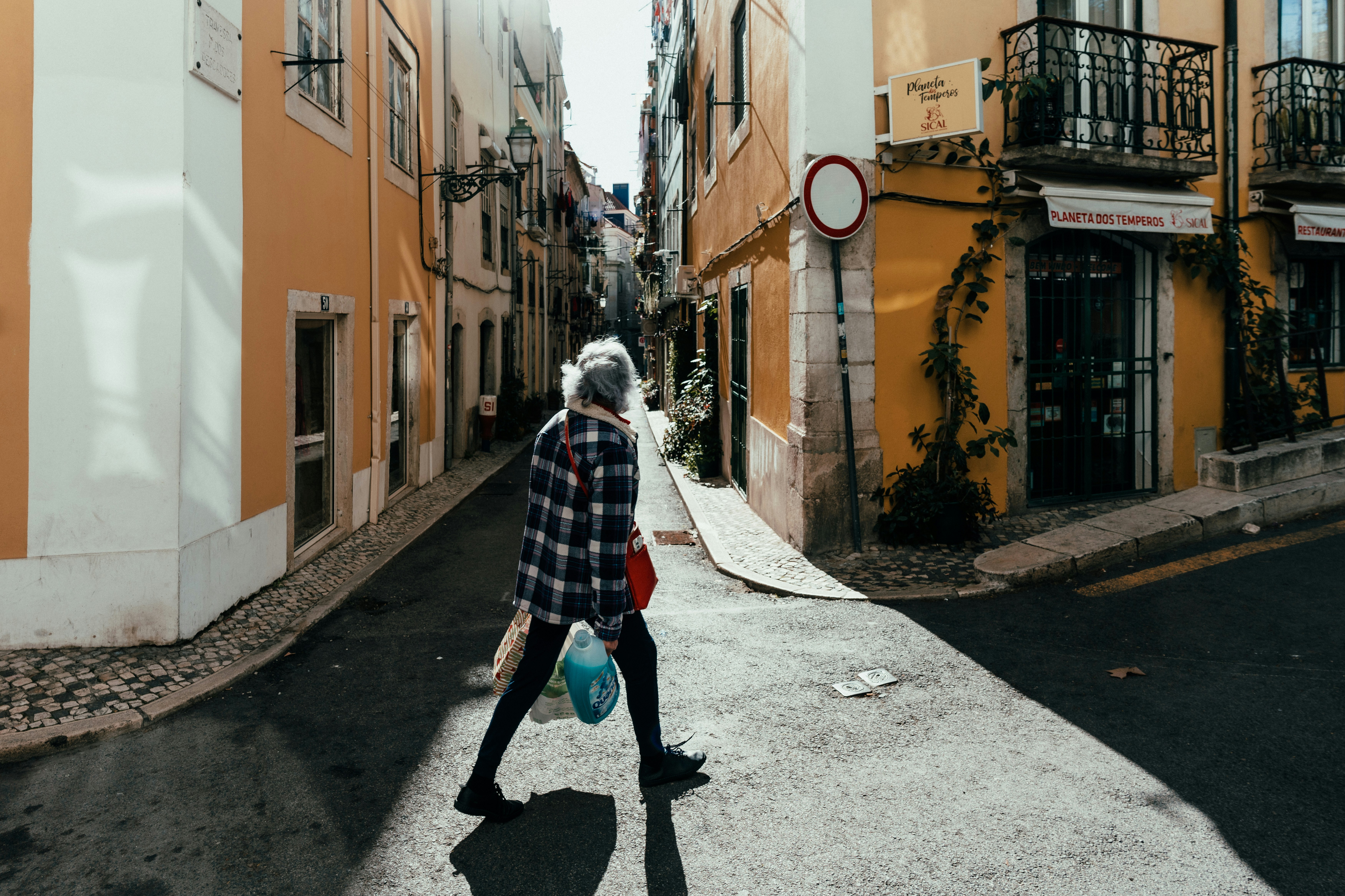 a person walking down a street with a bag