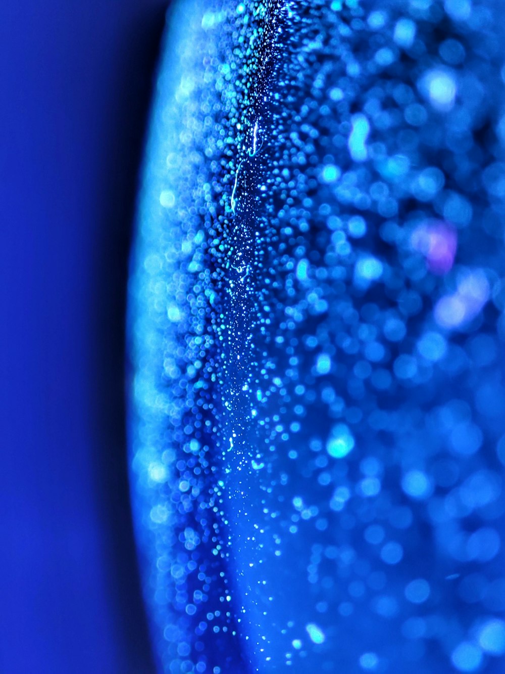 a close up shot of a blue glass