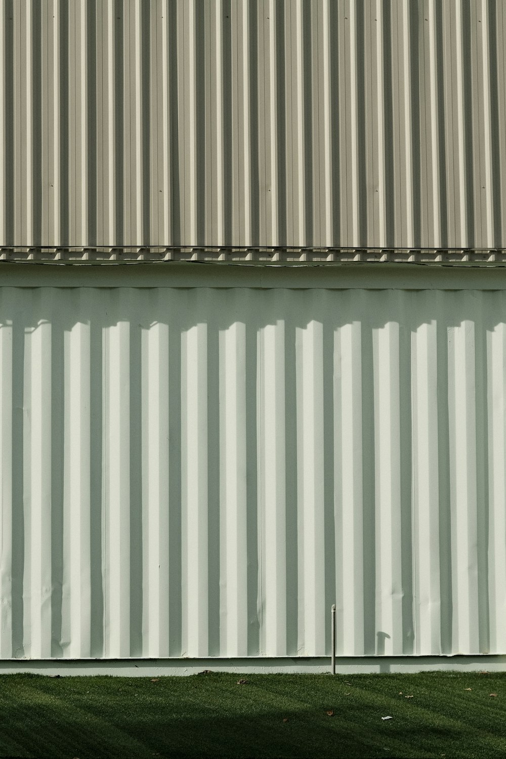 a person standing in front of a large metal building