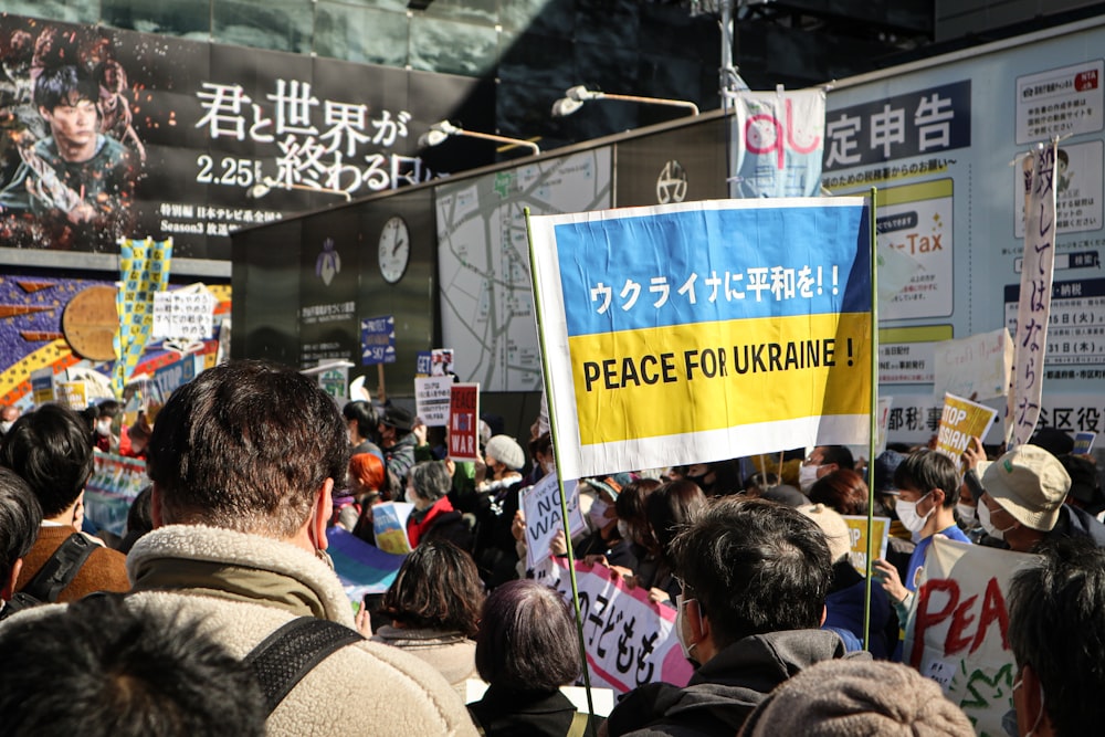 a large group of people holding up signs