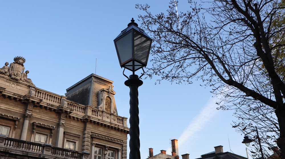 a lamp post with a building in the background
