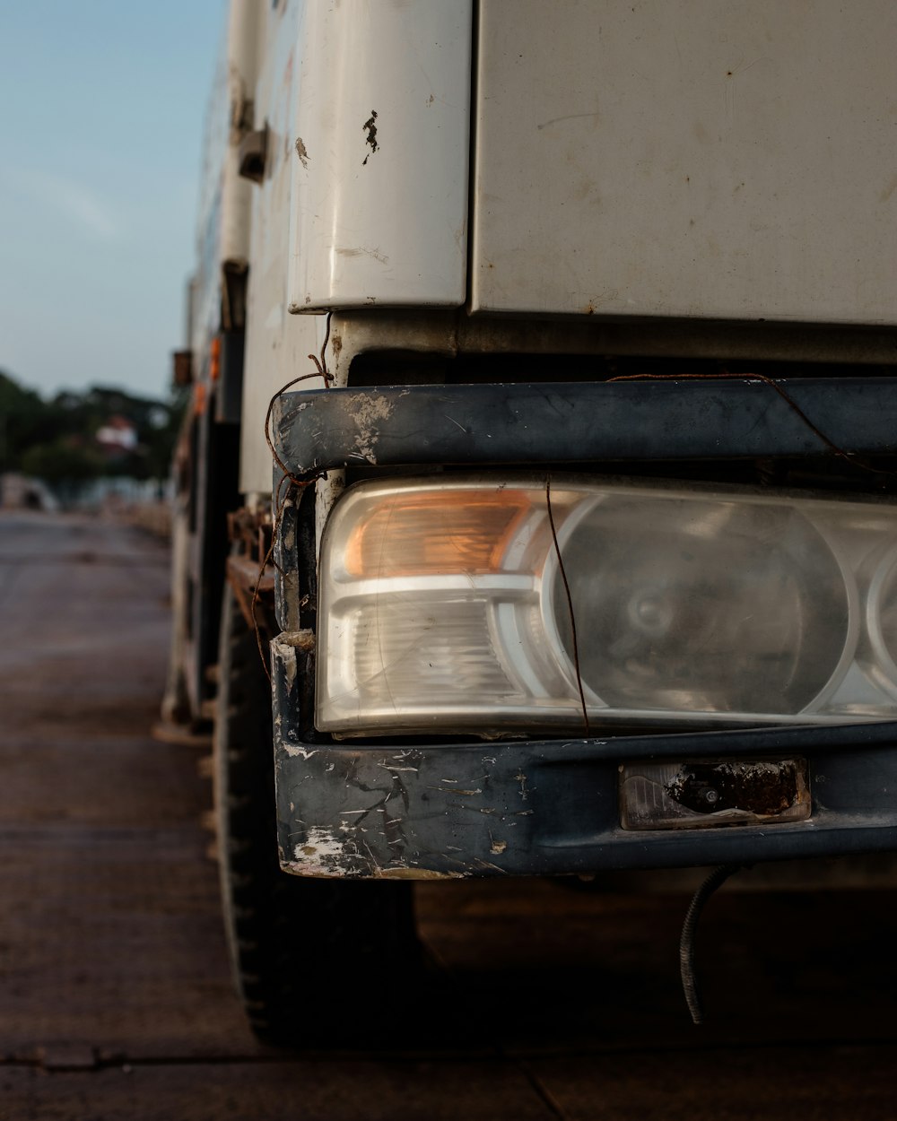 a white truck parked on the side of a road