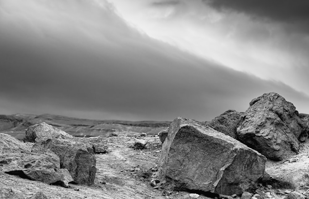 a black and white photo of rocks in the desert