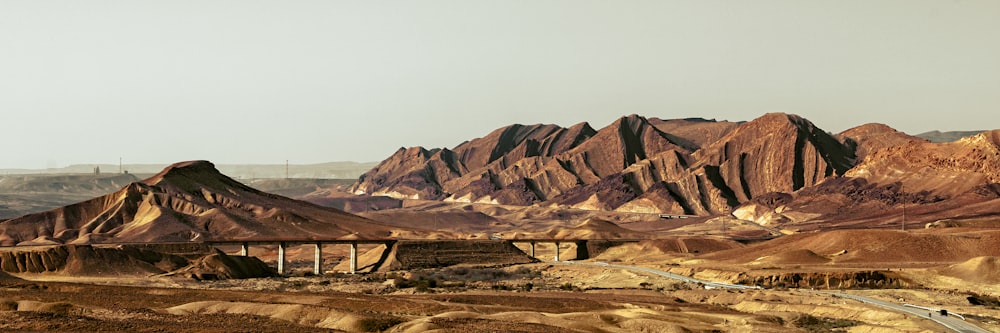 a mountain range with a bridge in the middle of it