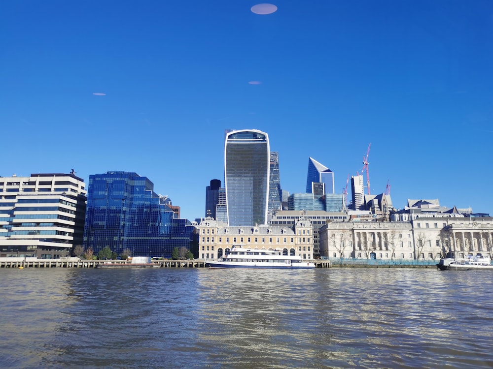 a large body of water with buildings in the background