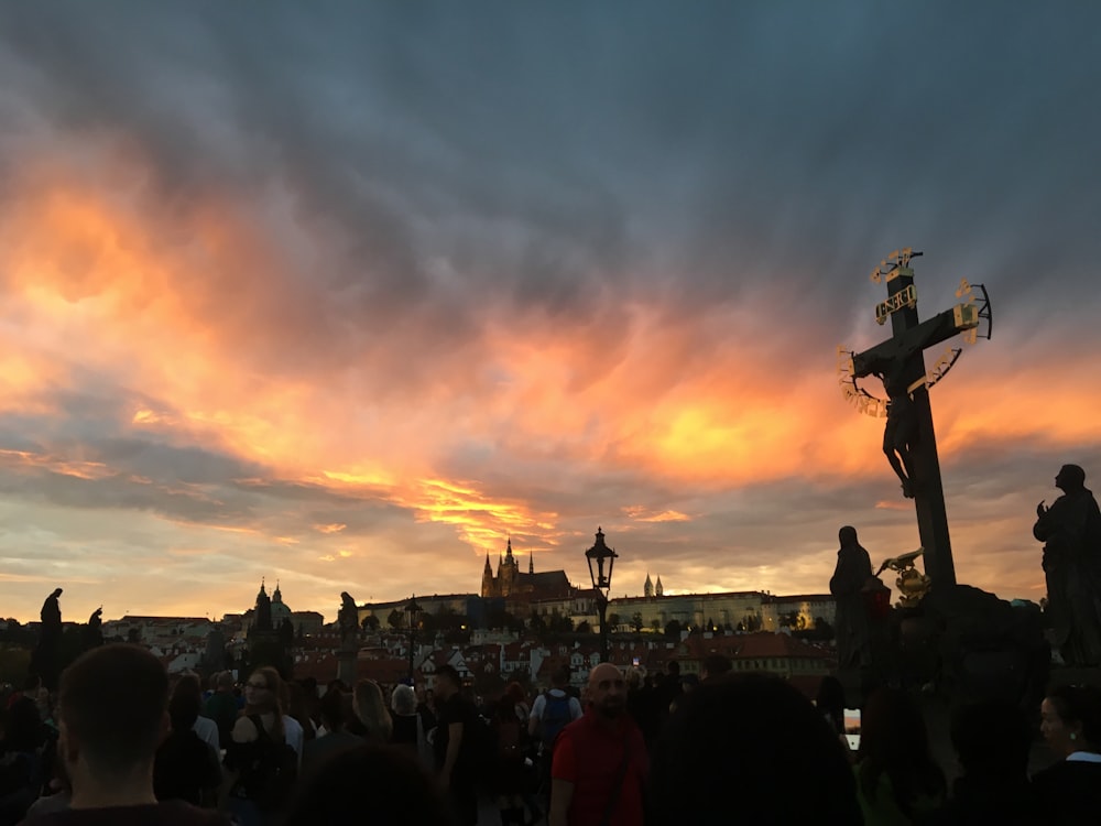 a crowd of people watching a colorful sunset