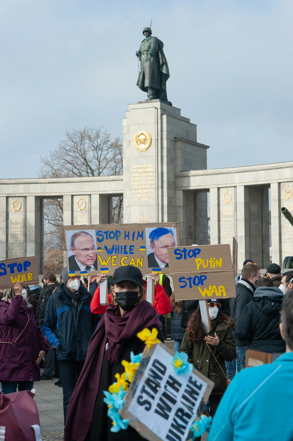 a group of people holding signs in front of a building