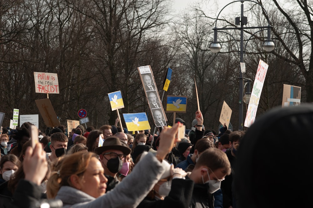 a large group of people holding up signs