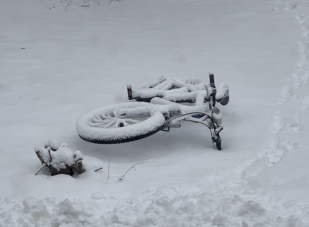 a bicycle is covered in snow on a snowy day