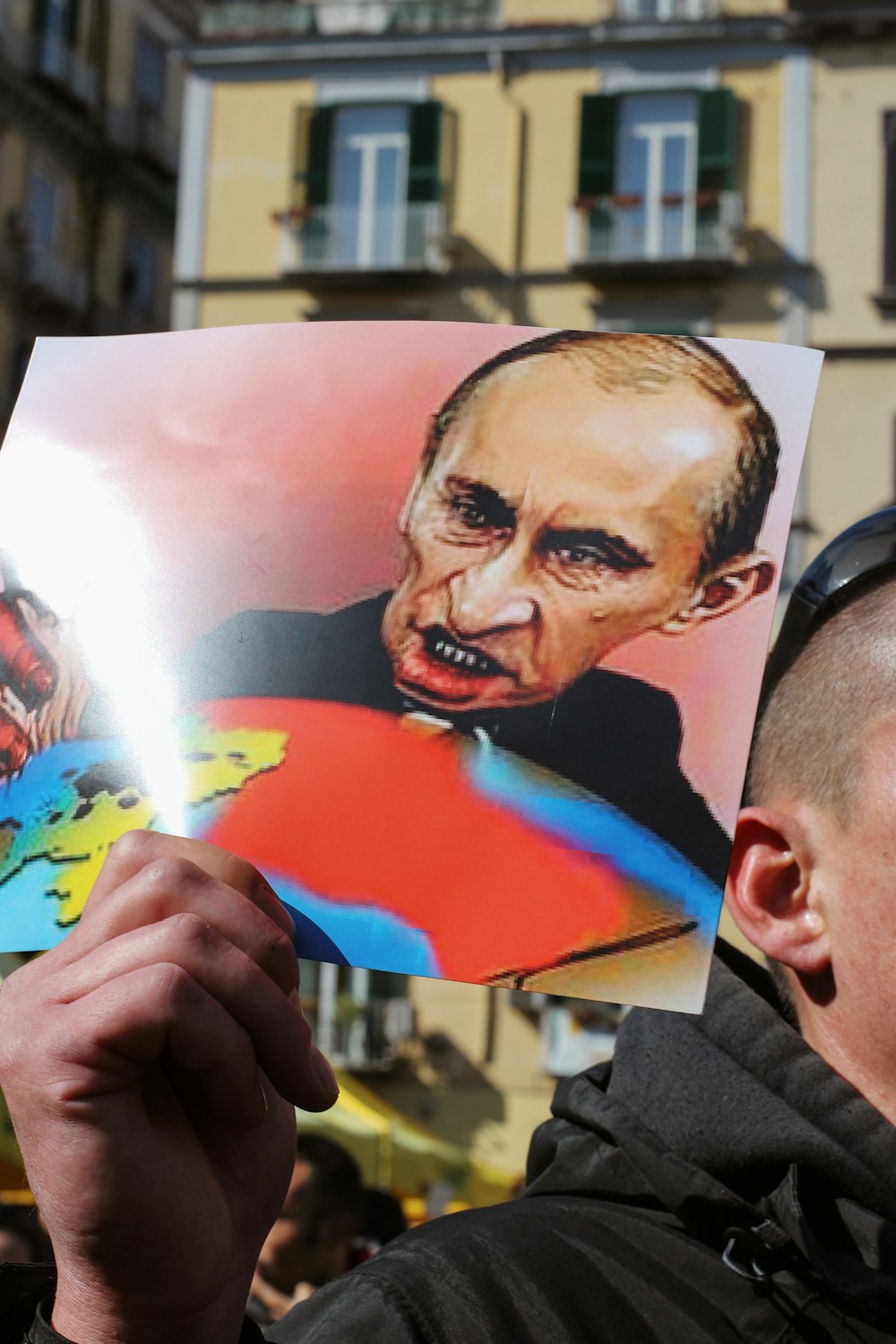 a man holding up a picture of a political figure