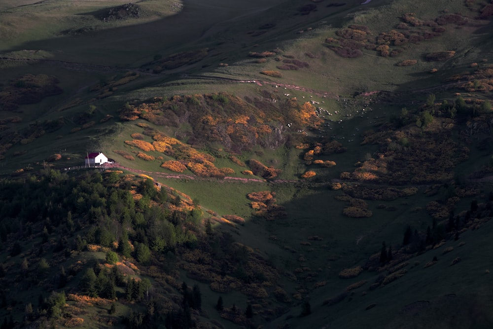 an aerial view of a house on a hill