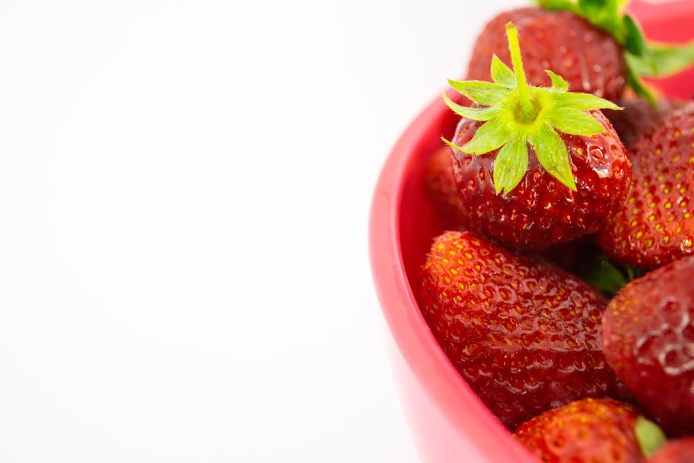a close up of a bowl of strawberries