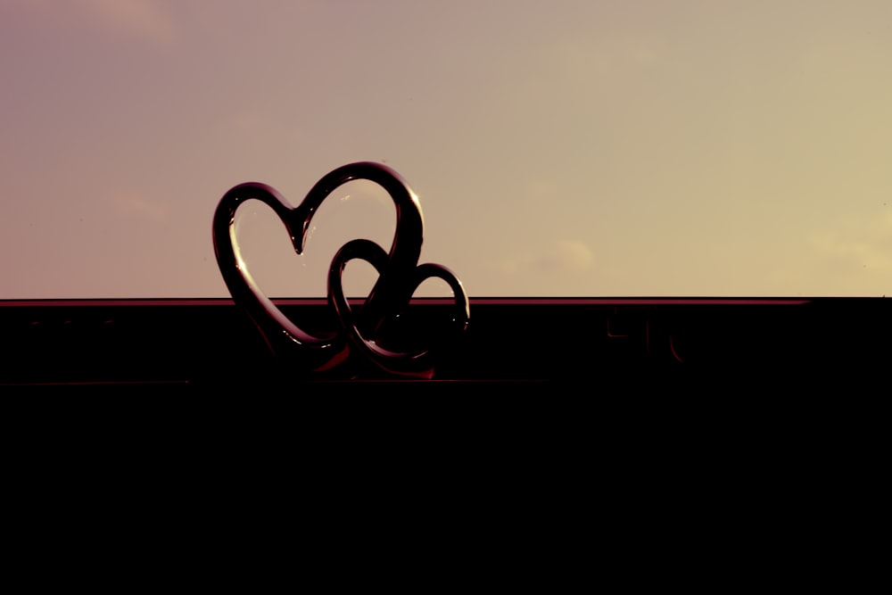 a heart shaped object sitting on top of a roof