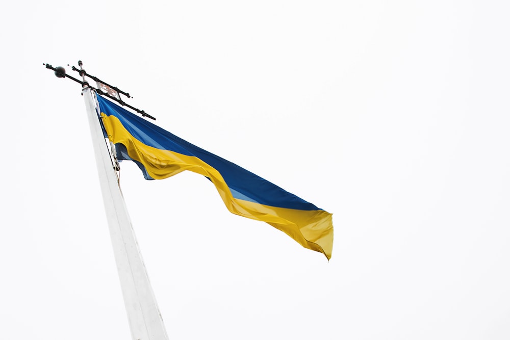 a blue and yellow flag flying in the wind