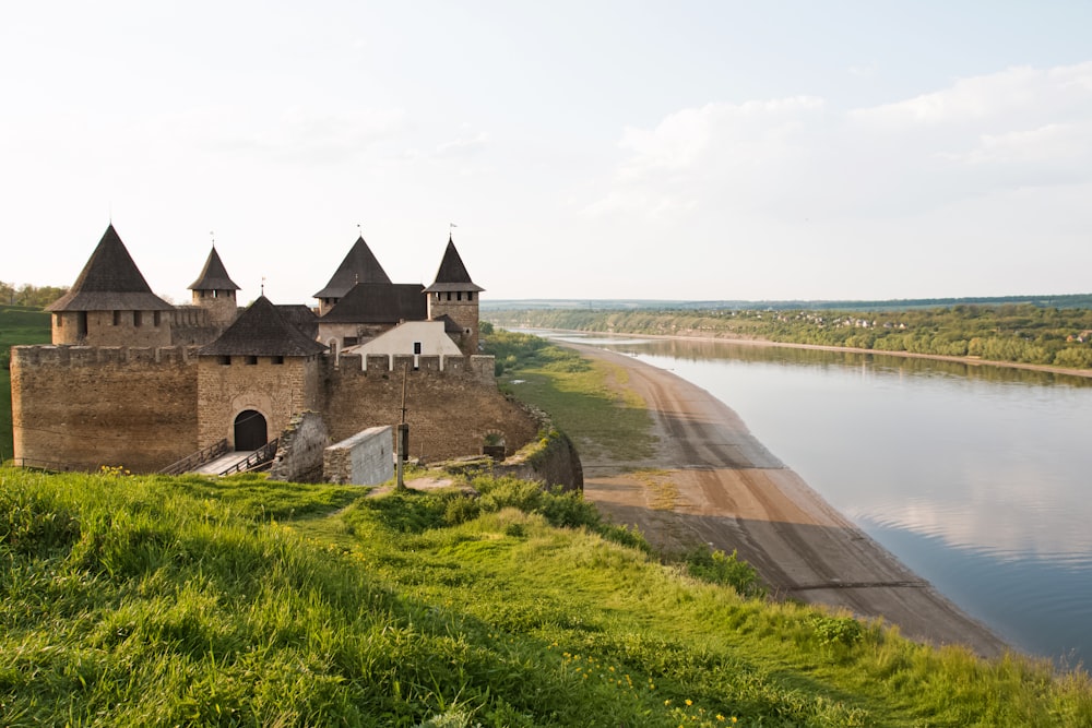 a large castle sitting on top of a lush green hillside