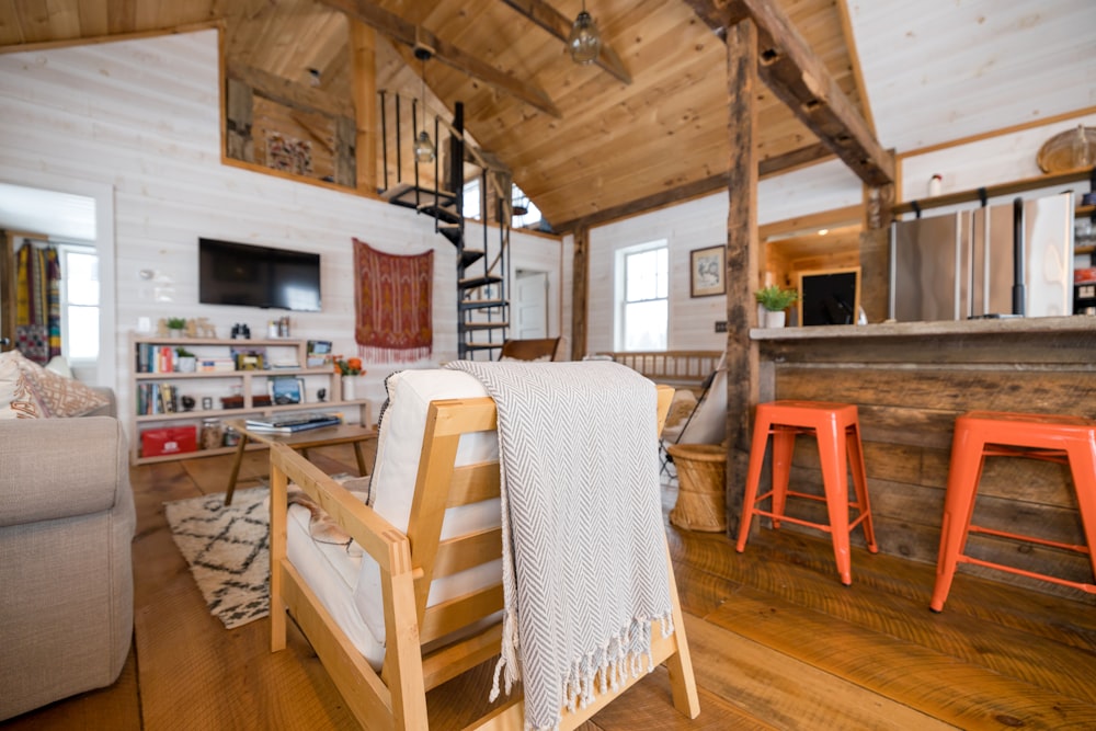 a living room filled with furniture and a wooden ceiling