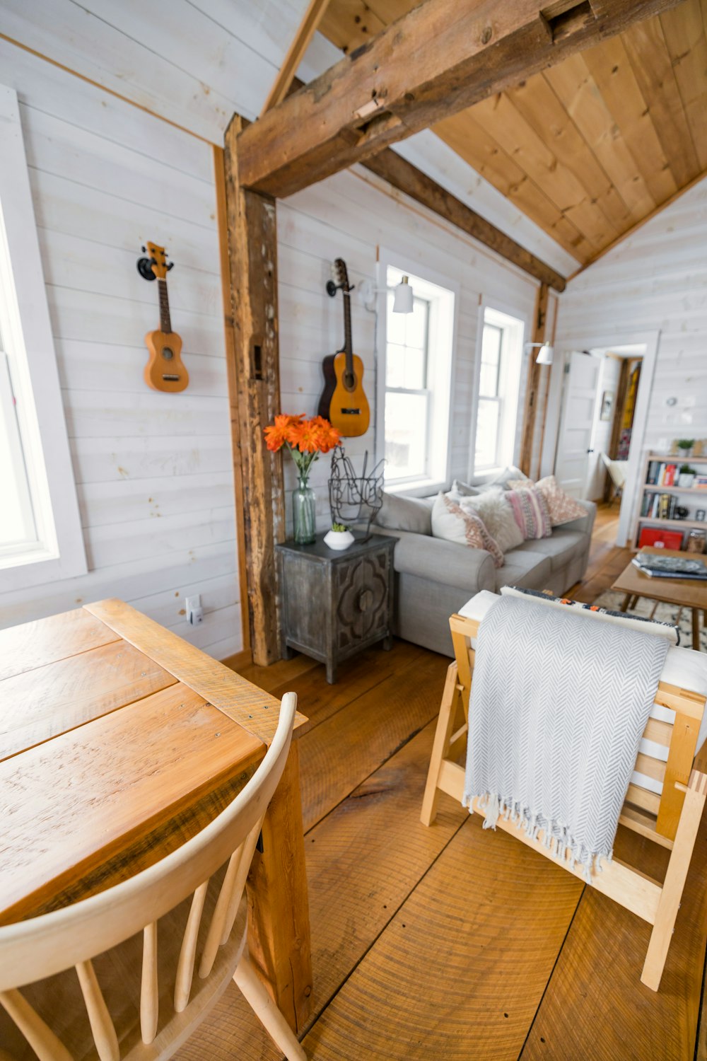 a living room with a couch a table and a guitar