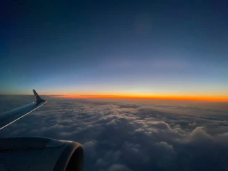 Sunset view from an airplane window showing a peaceful sky during a smooth flight