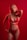 A person is standing against a red background, wearing red lingerie adorned with lace and ribbon details. They have blonde hair and are striking a confident pose with one hand on their hip and the other resting behind their neck.