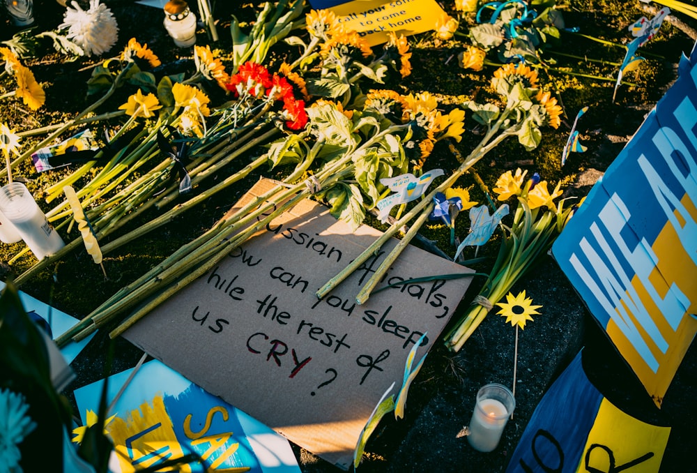 a bunch of flowers and a sign on the ground