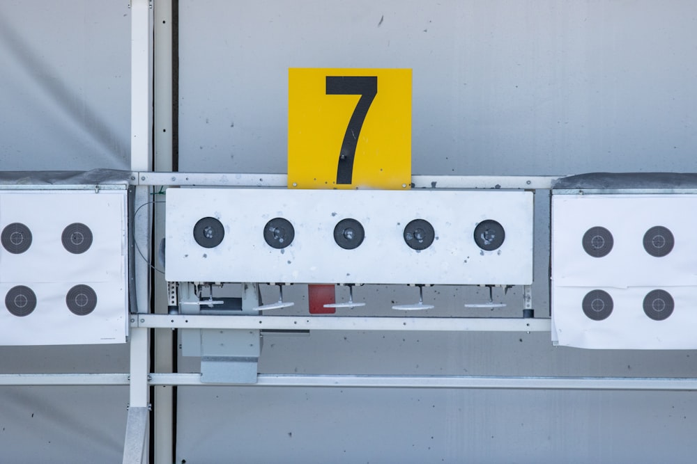 a number seven sign on top of a metal structure