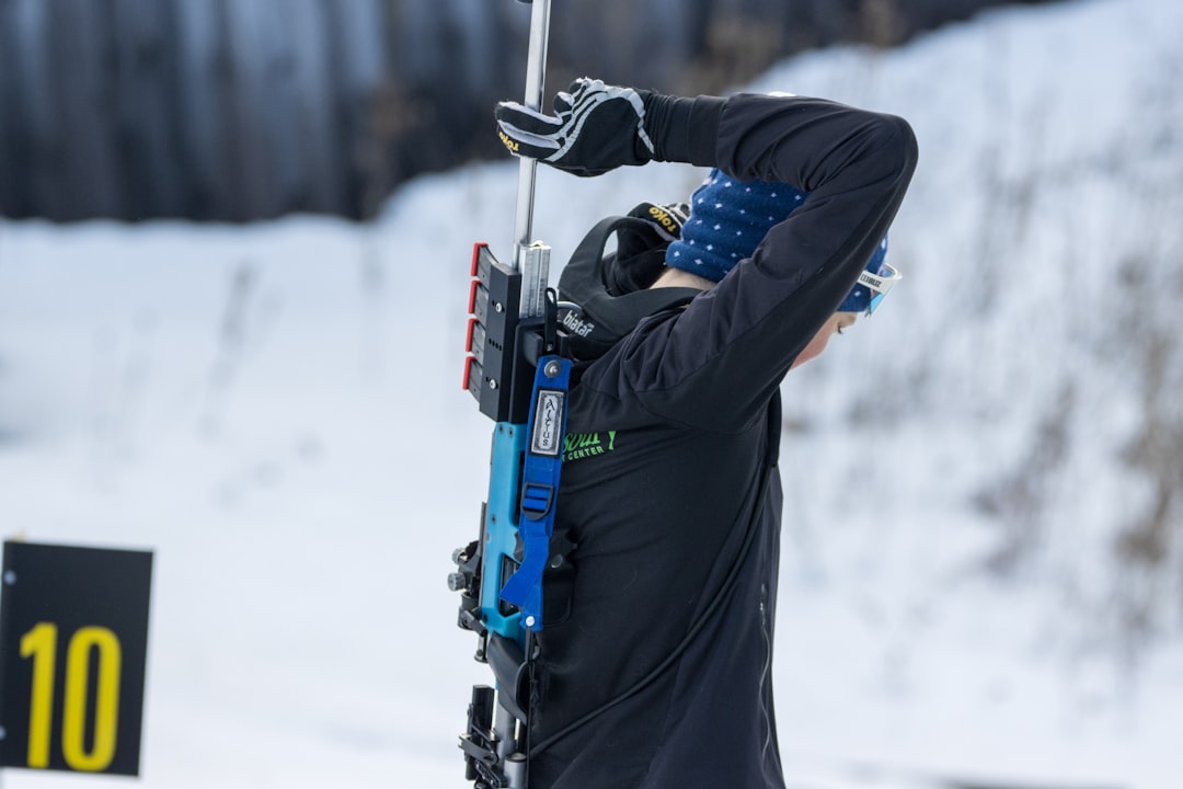 a man holding a ski pole in the snow,