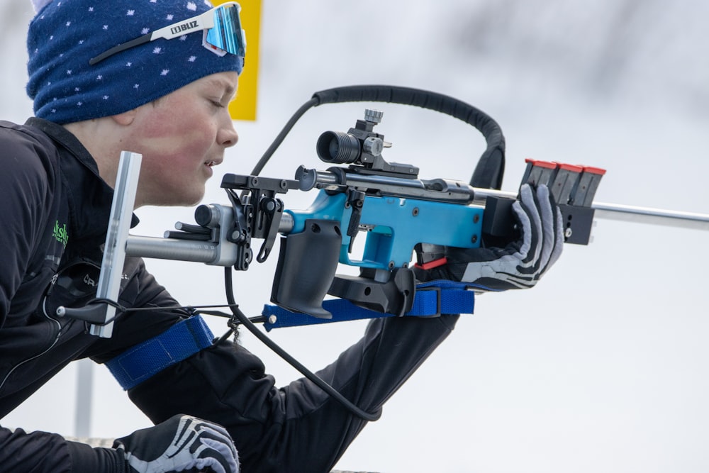 a man holding a bow with a camera attached to it