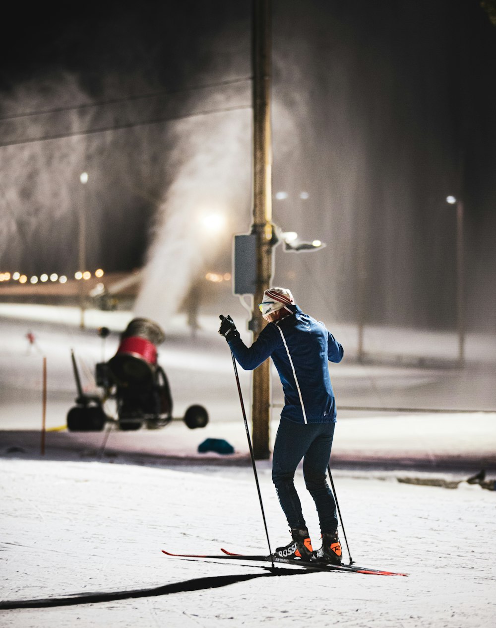 a man riding skis down a snow covered slope