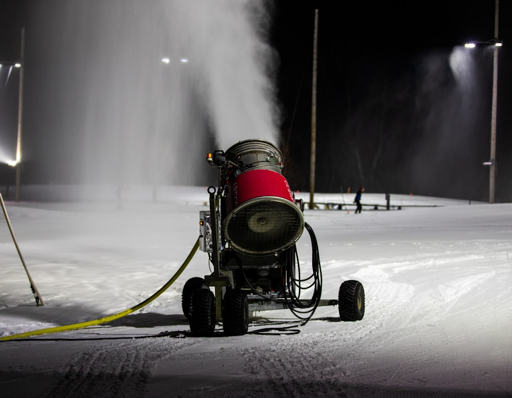 a snow blower is spraying snow on the ground
