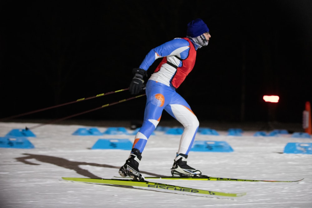 a man riding skis down a snow covered slope