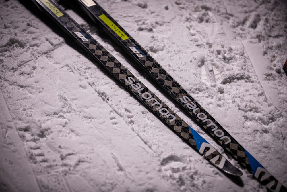 a pair of skis sitting on top of a snow covered ground