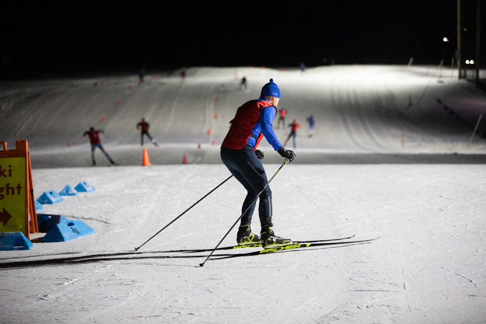 a man riding skis down a snow covered slope