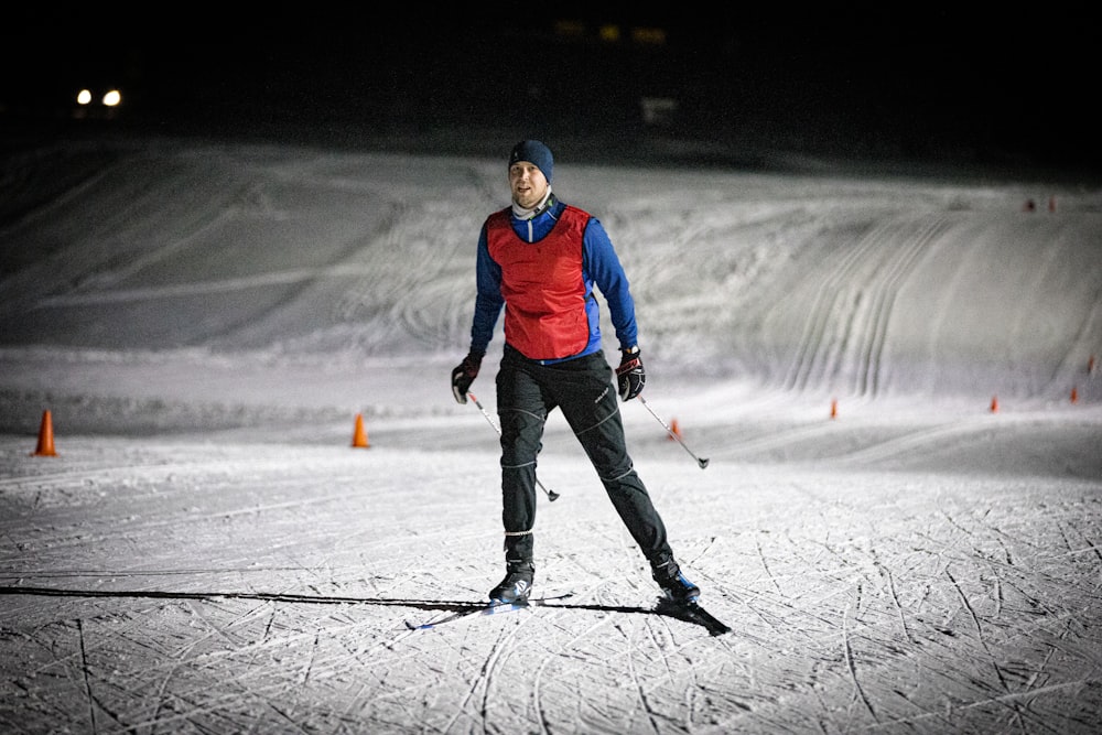 a man riding skis down a snow covered slope