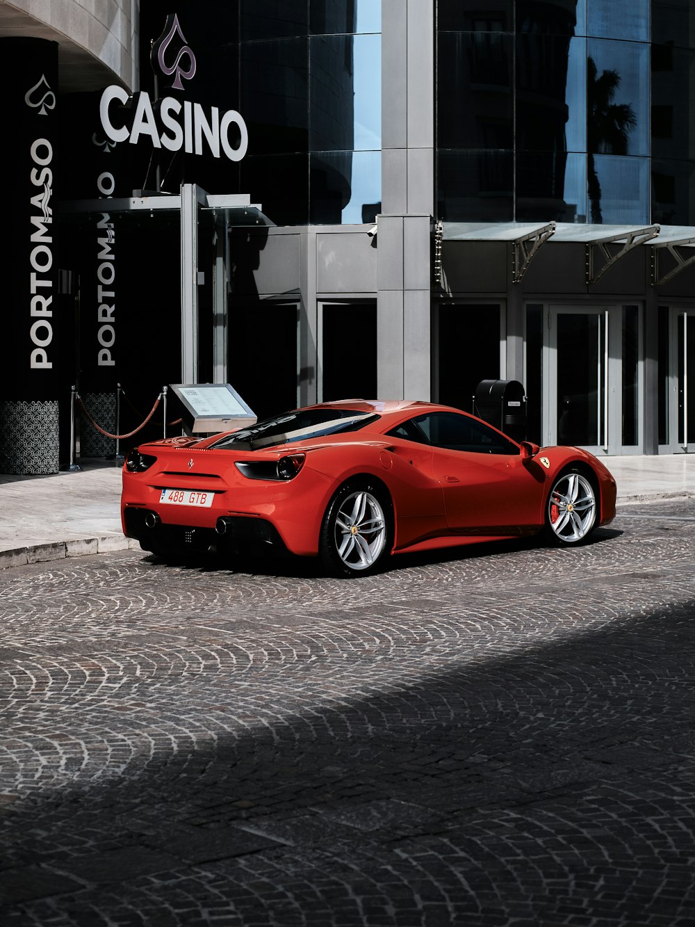a red sports car parked in front of a casino