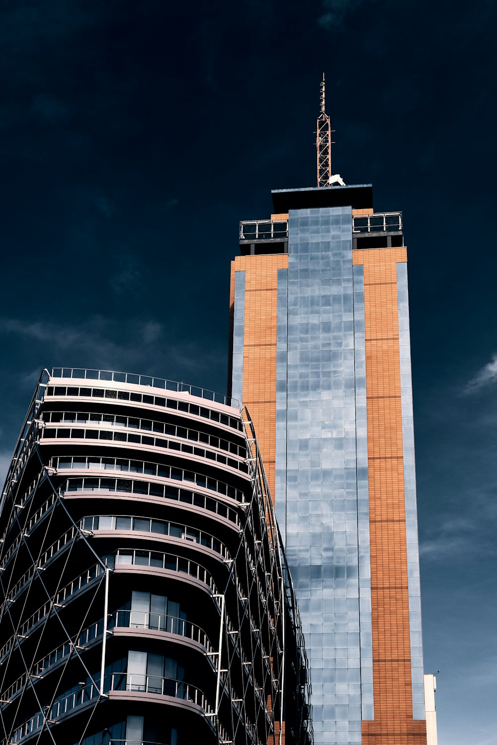 a tall building next to a very tall building