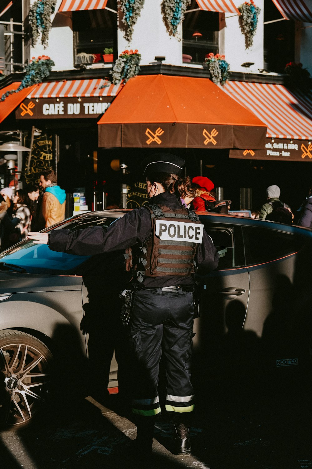 a police officer standing in front of a police car