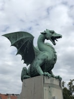 a statue of a green dragon on a pedestal