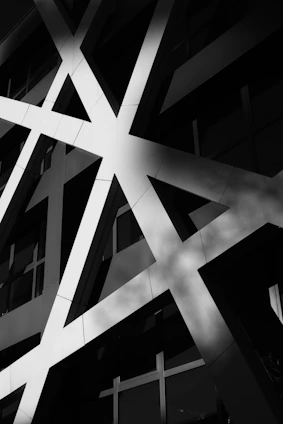 A striking black and yellow brutalist building facade with sharp geometric shapes and bold shadows.