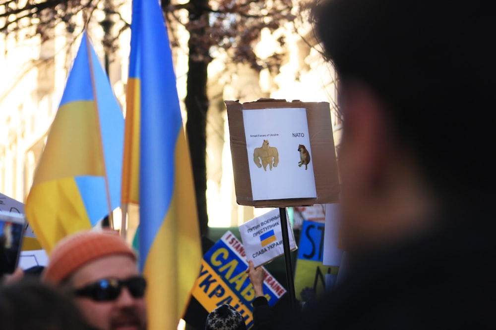 a group of people holding signs and flags