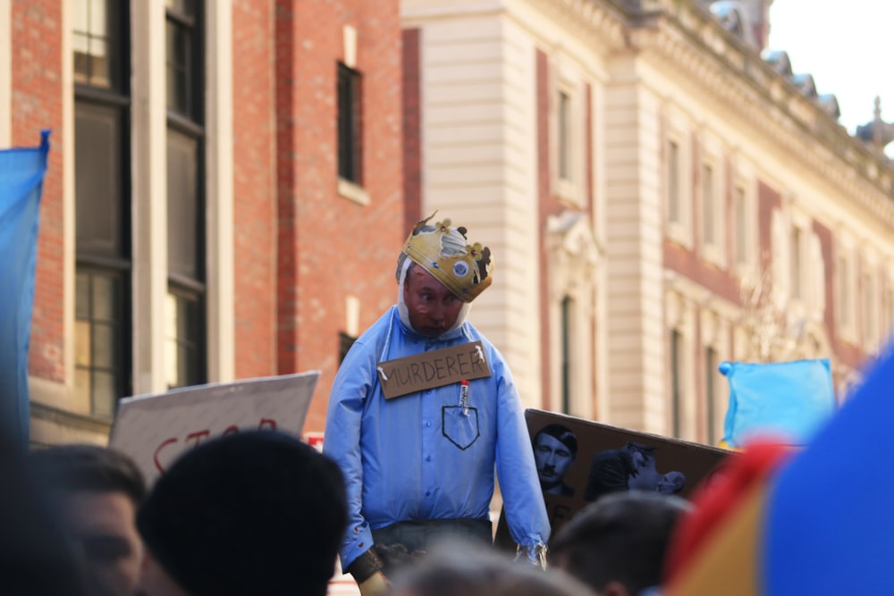 a man with a box on his head walking down the street