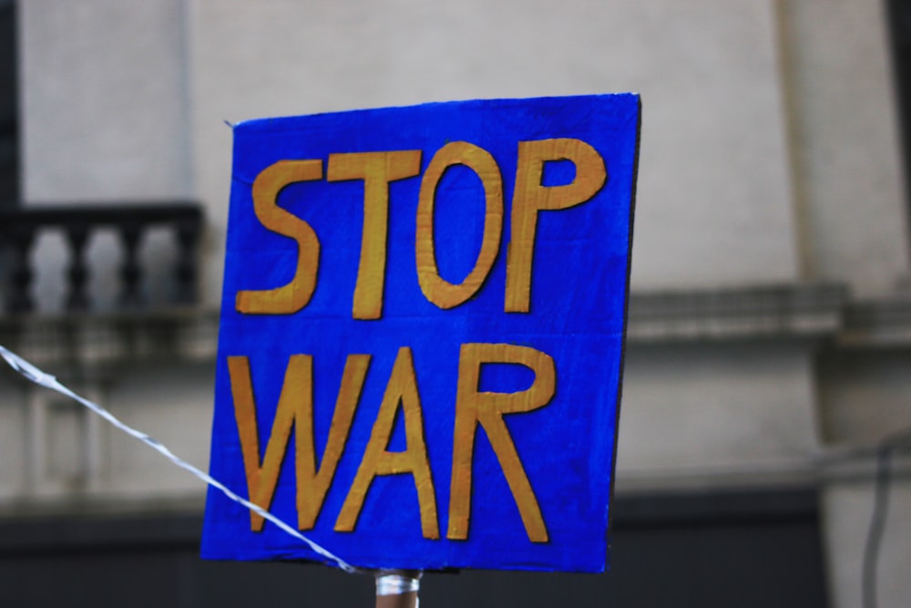 a blue sign that says stop war on it