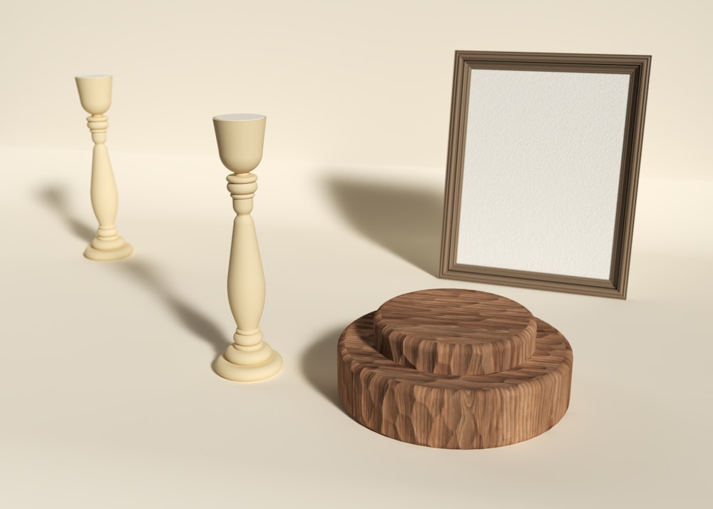 a picture frame, candle holders, and a mirror on a table