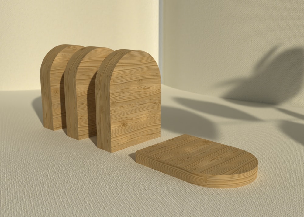 a set of three wooden coasters sitting on top of a white floor