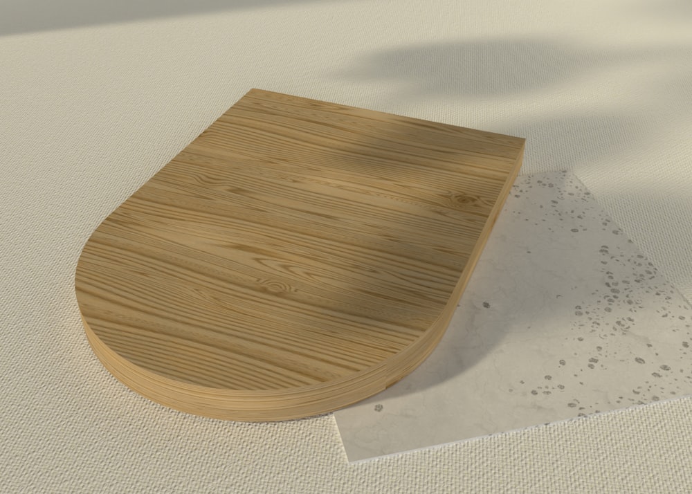 a wooden toilet seat on a white surface