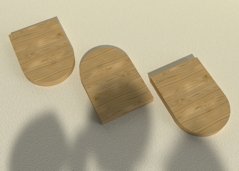 trois morceaux de bois posés sur une surface blanche